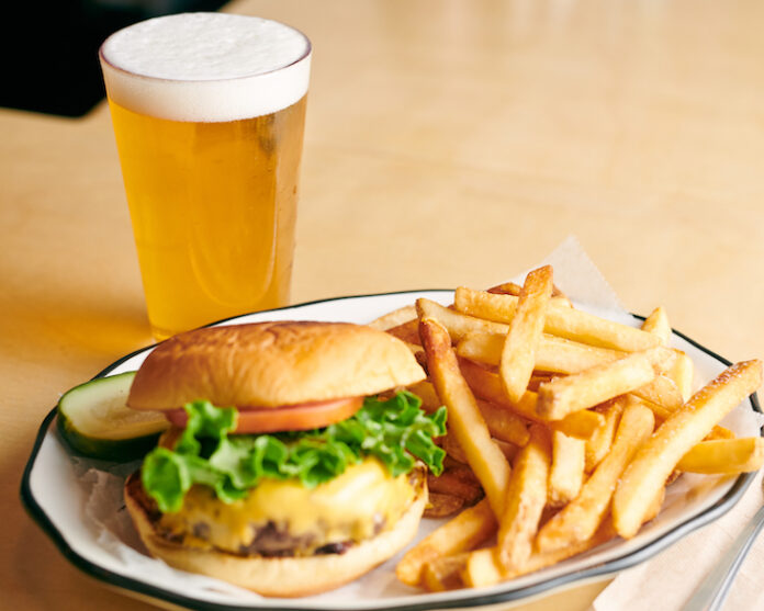 a draft beer, burger and fries