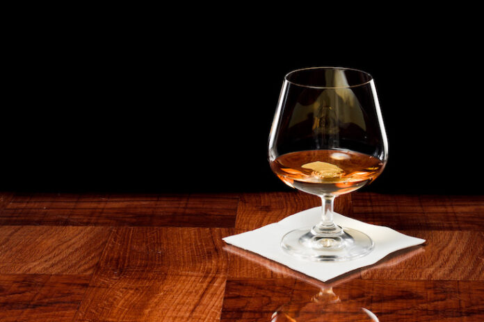 Brandy snifter on a wood bar top