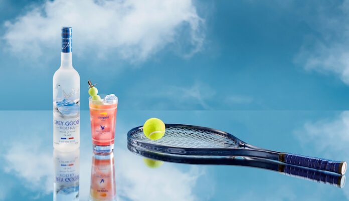 Grey Goose vodka bottle with Honey Deuce cocktail and tennis raquet