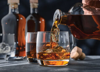 Spirit Reviews: Bourbons for 2025 brown spirits poured from decanter into rocks glass