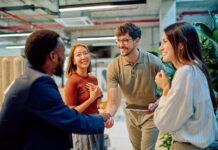 Managers shaking hands during a business meeting in modern office