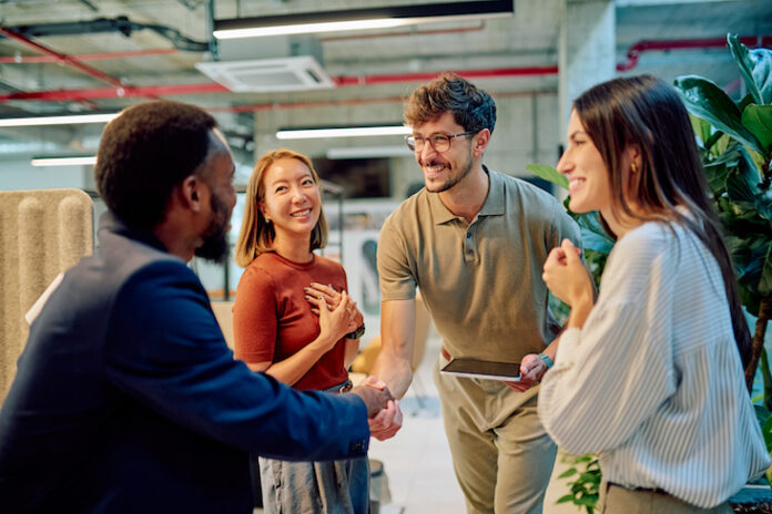 Managers shaking hands during a business meeting in modern office