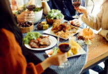people enjoying wine and food